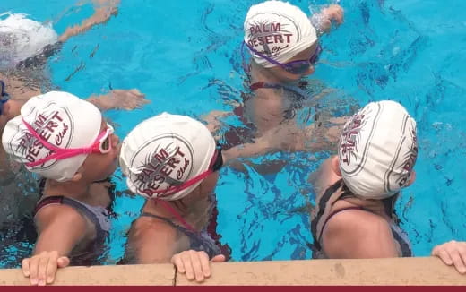 a group of women in swim gear in a pool