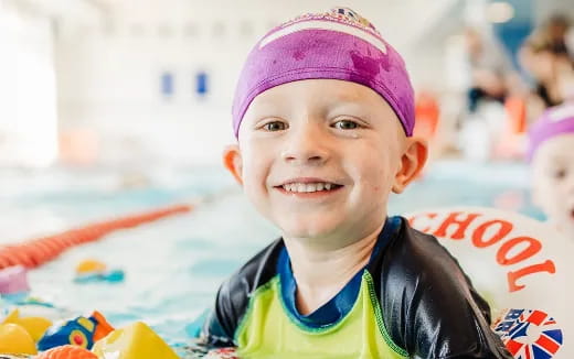 a boy wearing a purple hat