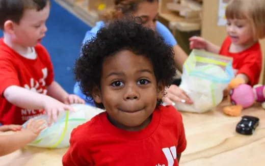 a group of children in red shirts