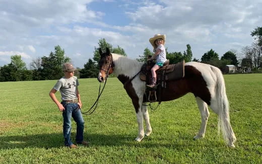 a person and a girl on a horse