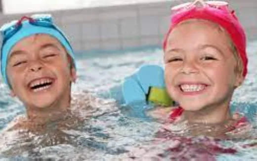 a couple of children in a pool
