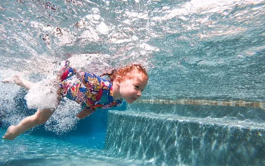 a boy in a pool