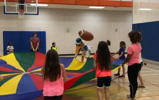 a group of kids playing basketball