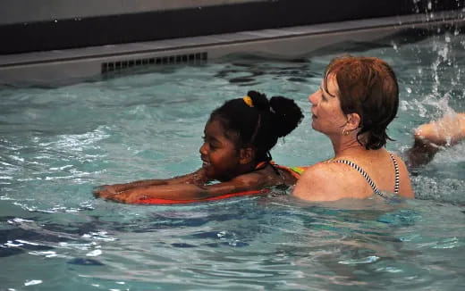 a man and a girl in a pool