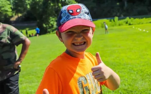 a boy wearing a baseball hat