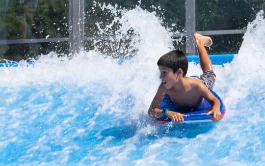 a boy riding a surfboard