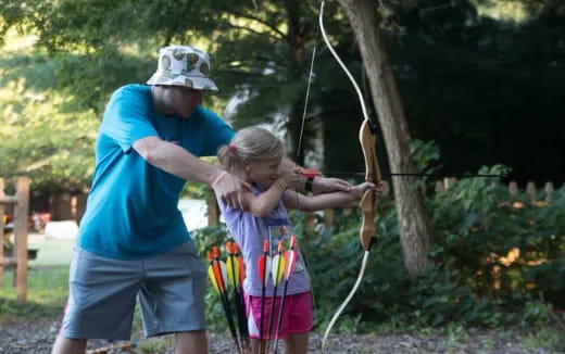 a person and a girl holding bows and arrows