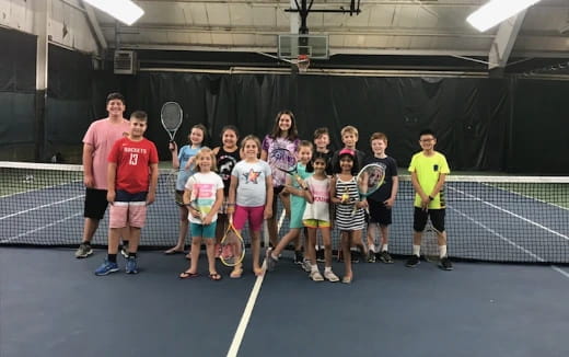 a group of people holding tennis rackets