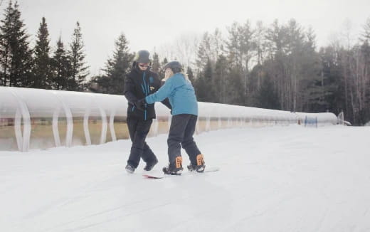 a man and woman on snow skis