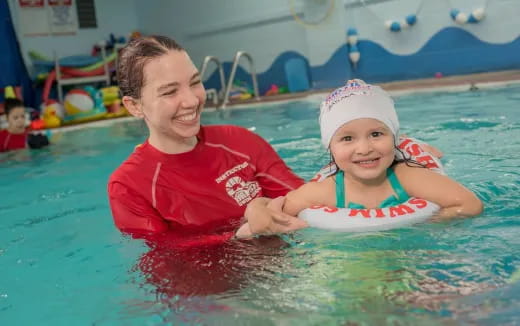 a person and a child in a pool