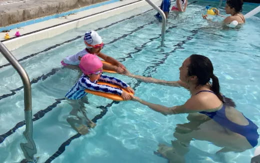 a person and a child in a pool