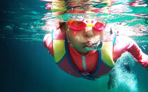a person in a pool wearing a garment