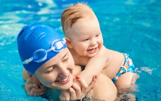 a baby and a baby in a pool