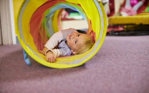 a baby lying in a ball
