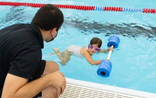 a man and a child in a pool