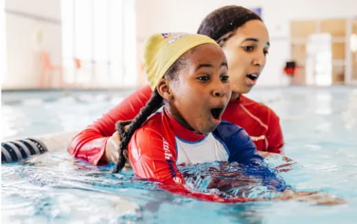 a couple of kids in a pool