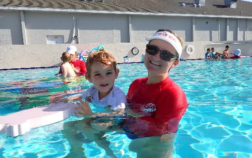 a person and a boy in a pool