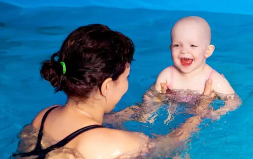 a person holding a baby in the water