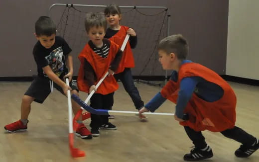 a group of kids playing hockey