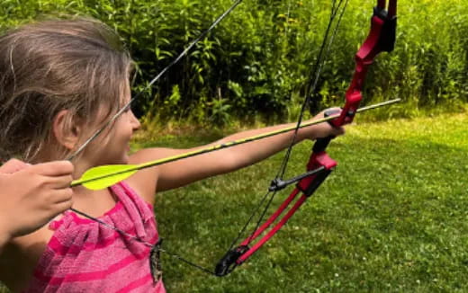 a girl shooting a bow