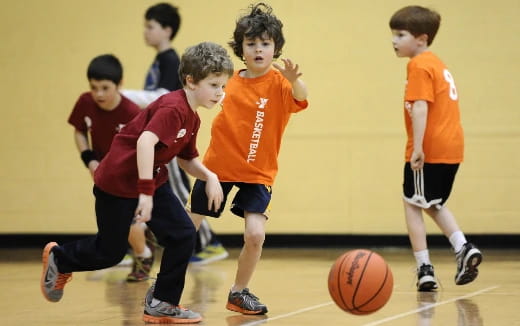 a group of kids playing basketball