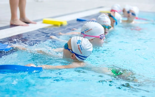 a group of swimmers in a pool