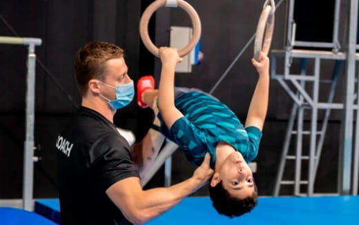 a person lifting another man up