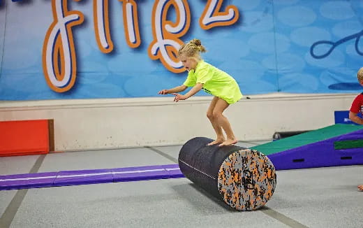 a girl jumping on a trampoline