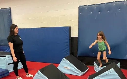 a person and a girl on a trampoline