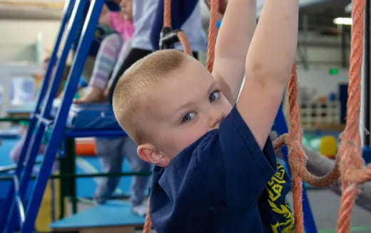 a baby reaching for a rope