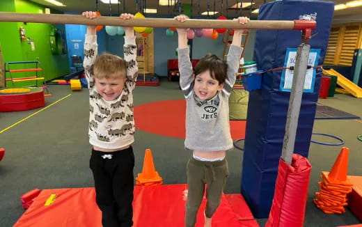 a couple of kids playing on a playground