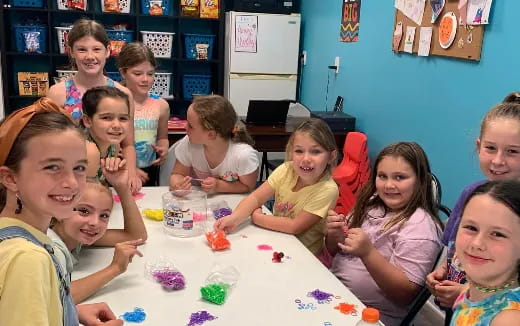 a group of children sitting around a table