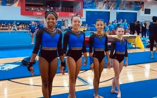 a group of women in swimsuits on a court