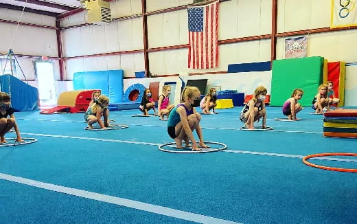 a group of people on mats in a gym