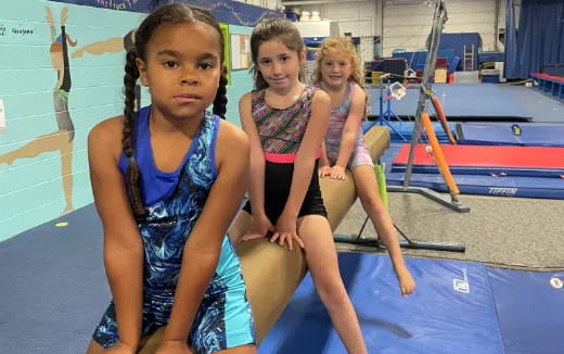 a group of girls in swimsuits by a pool