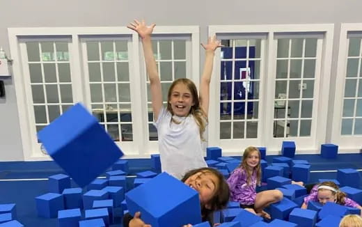 a girl raising her arms