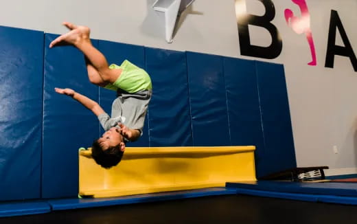 a man doing a handstand on a mat