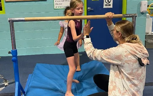 a woman lifting a girl up