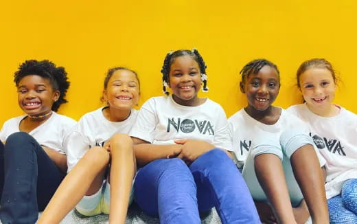 a group of people sitting together smiling