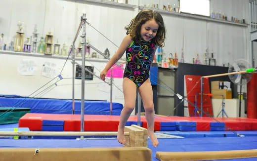 a girl jumping on a trampoline