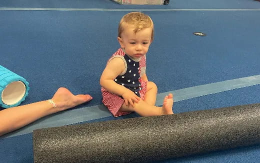 a baby sitting on a mat