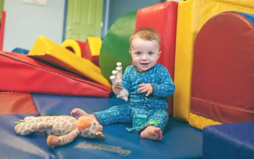 a baby sitting on a slide