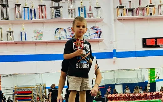 a boy holding a trophy