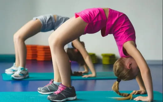 a woman doing a plank on a mat