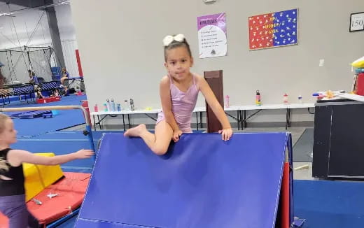 a girl sitting on a trampoline