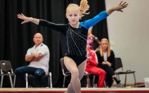 a woman in a leotard dancing on a stage