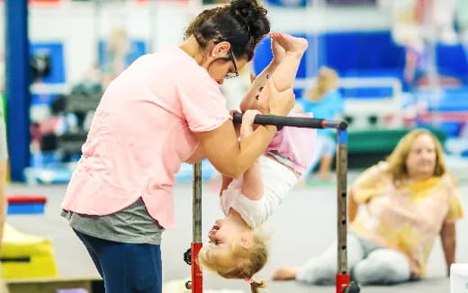 a woman lifting a man up