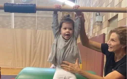 a person lifting another woman up