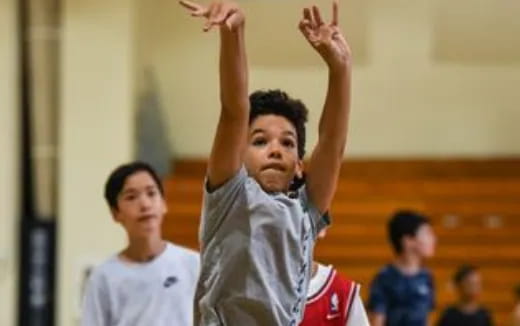 a boy raising his hands