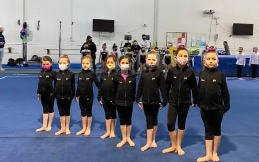 a group of children in black and white uniforms